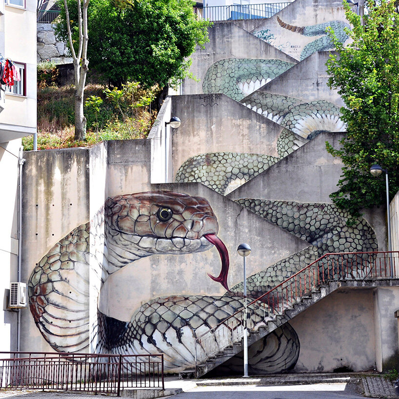 a giant snake moves down a massive staircase in this graffiti by SFHIR in portugal