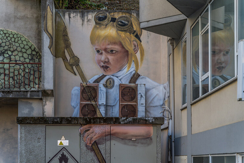 a giant snake moves down a massive staircase in this graffiti by SFHIR in portugal