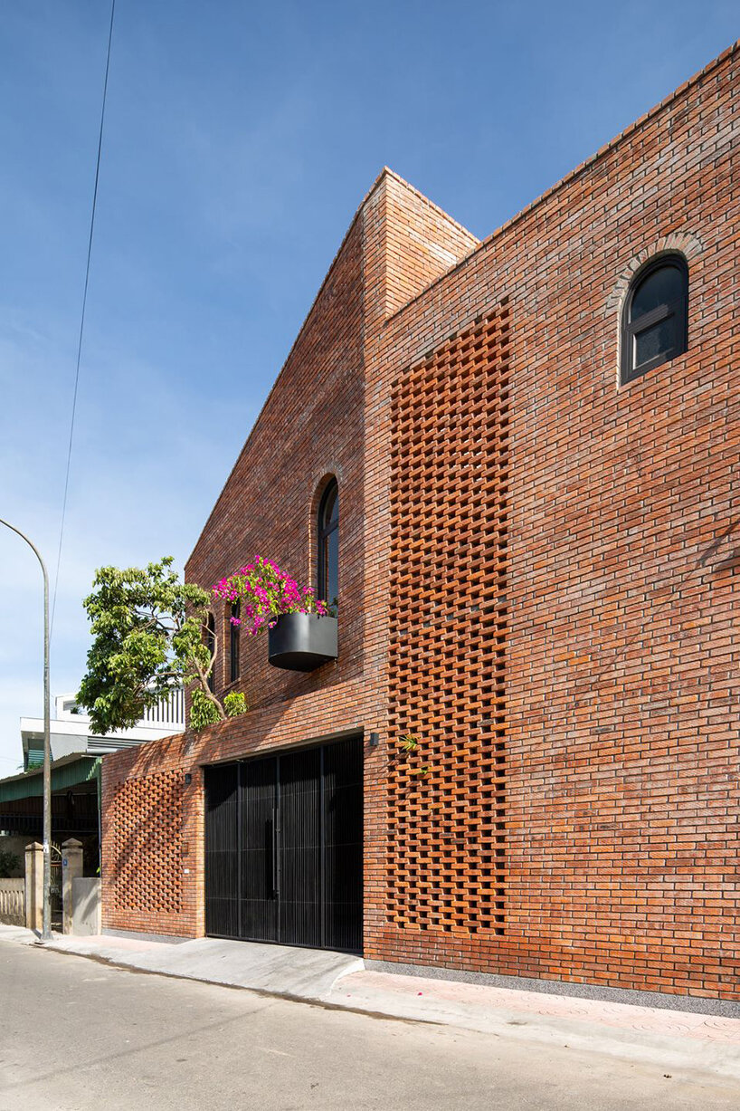 dom architect studio incorporates nature into brick-clad house in vietnam