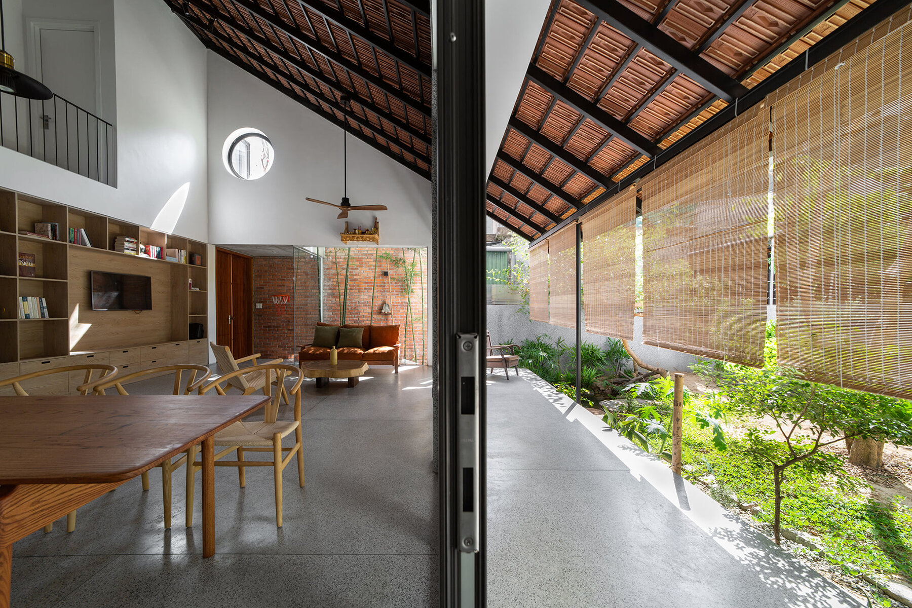 dom architect studio incorporates nature into brick-clad house in