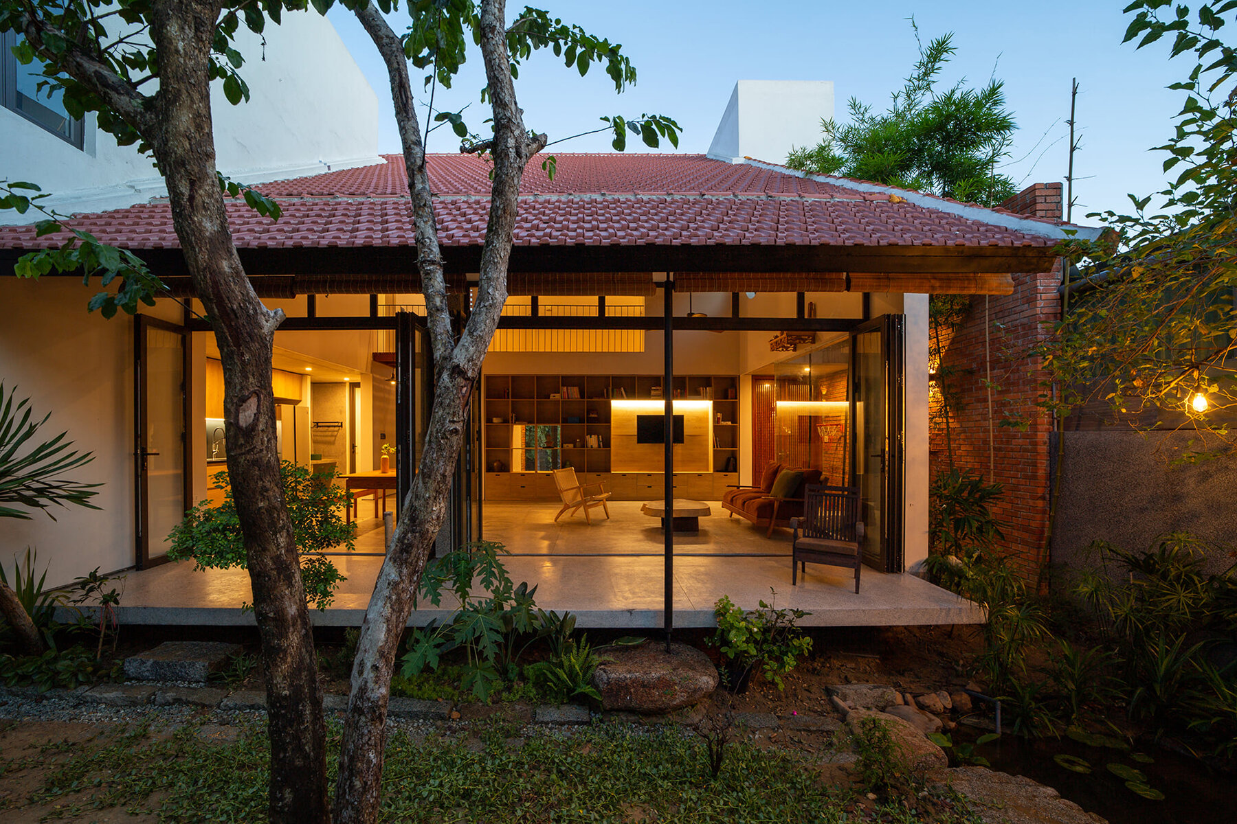 dom architect studio incorporates nature into brick-clad house in vietnam