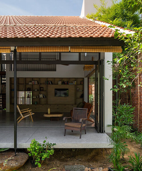 dom architect studio incorporates nature into brick-clad house in bustling vietnamese center