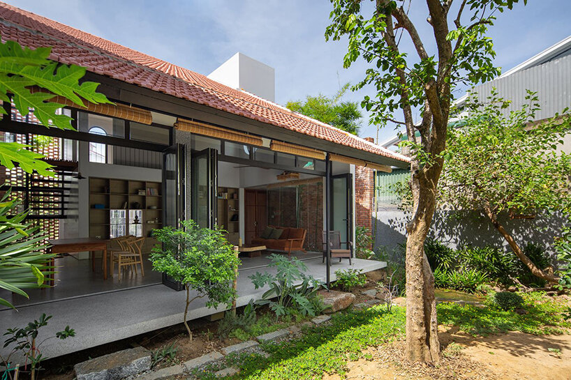 dom architect studio incorporates nature into brick-clad house in vietnam