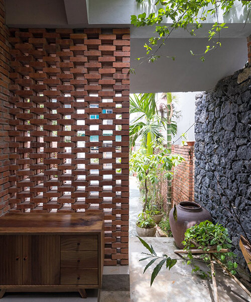 red bricks + rustic black stones clad this dwelling in the heart of vietnamese hillside