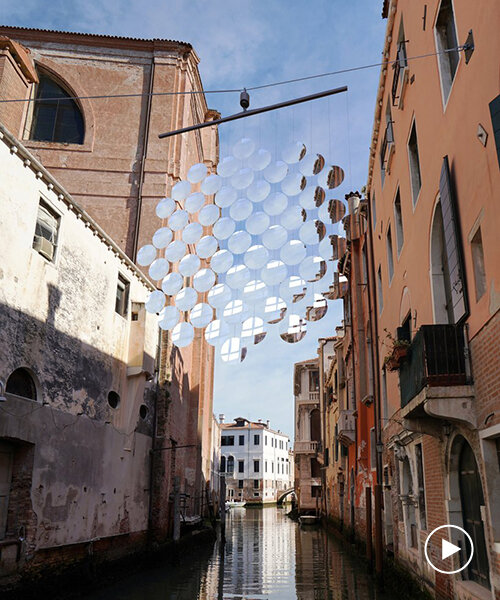 vincent leroy imagines giant mobile of magnifying glass floating above venetian boats