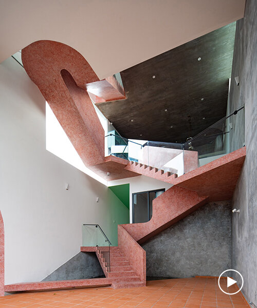 serpentine pink staircase highlights the inclination of AD+studio's house in vietnam