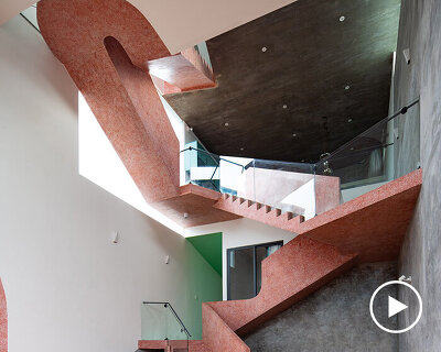 serpentine pink staircase highlights the inclination of AD+studio's house in vietnam