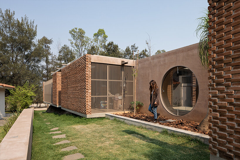 opposite circular openings offer visual connection through 'casa UC' in mexico