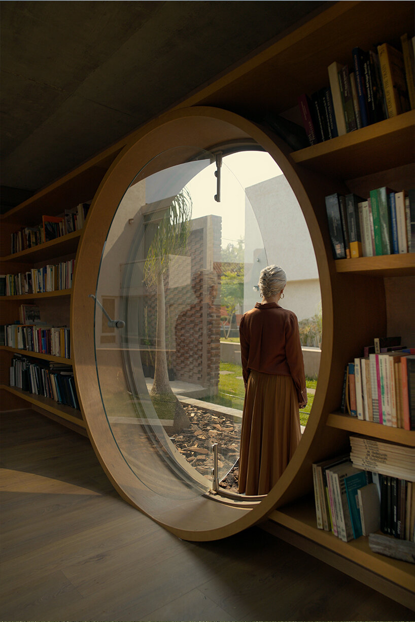 opposite circular openings offer visual connection through 'casa UC' in mexico