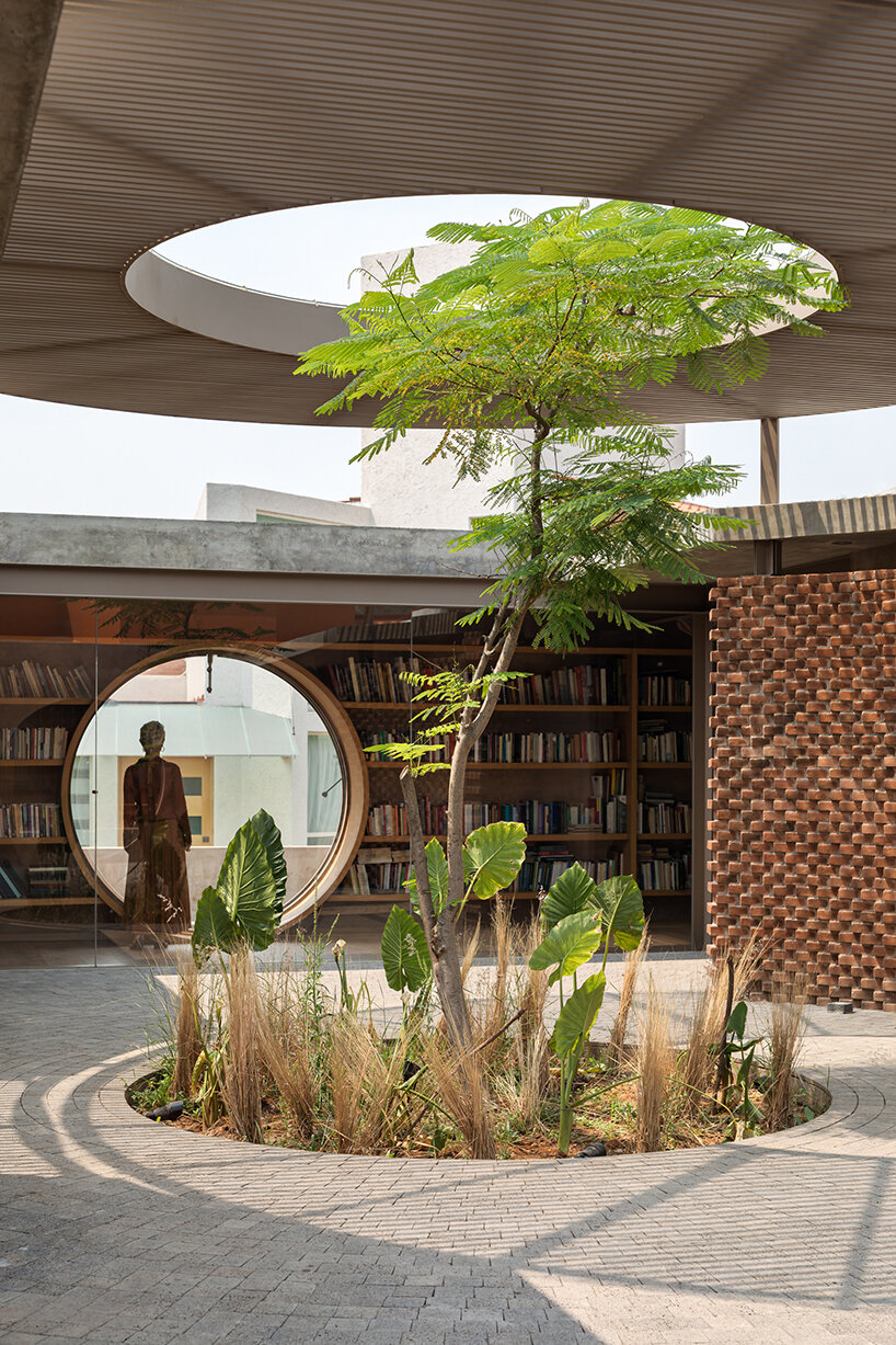opposite circular openings offer visual connection through 'casa UC' in mexico