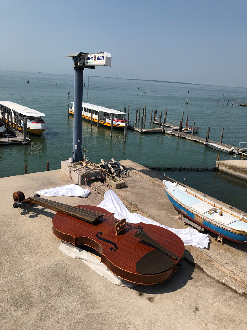 giant violin floats down venice's grand canal complete with string