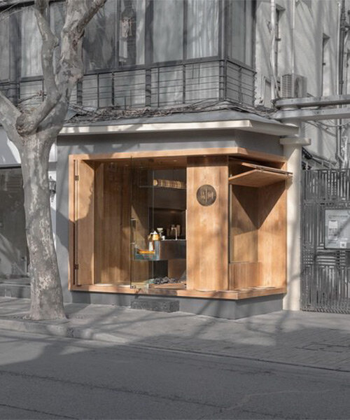 golucci embeds wooden box café into the concrete urban fabric of shanghai