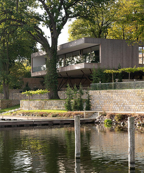 modern treehouse by carlos zwick perches above a lakeside in potsdam, germany
