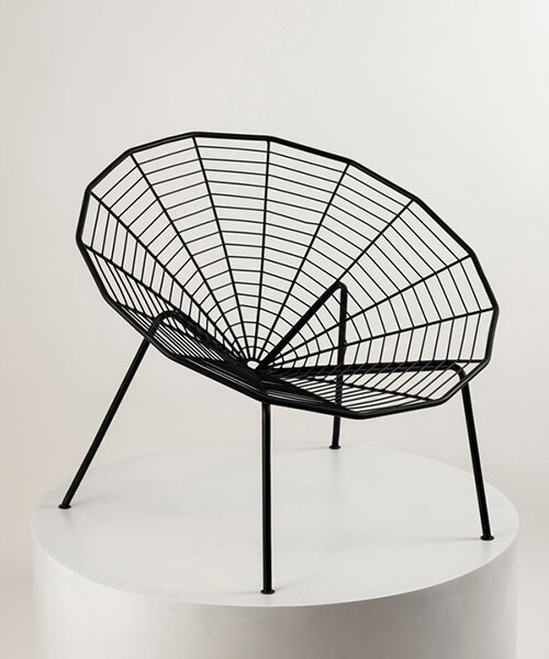 this minimal black iron chair is inspired by spiders