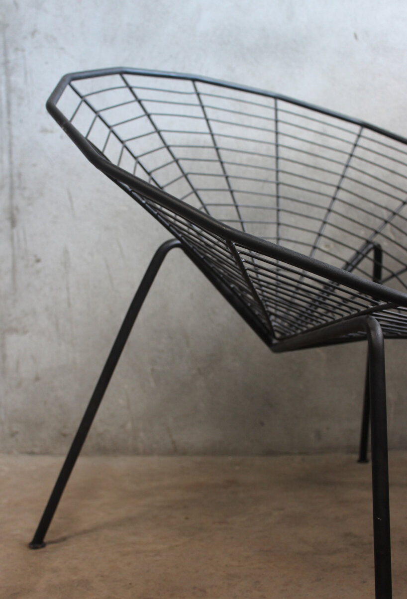 this minimal black iron chair is inspired by spiders