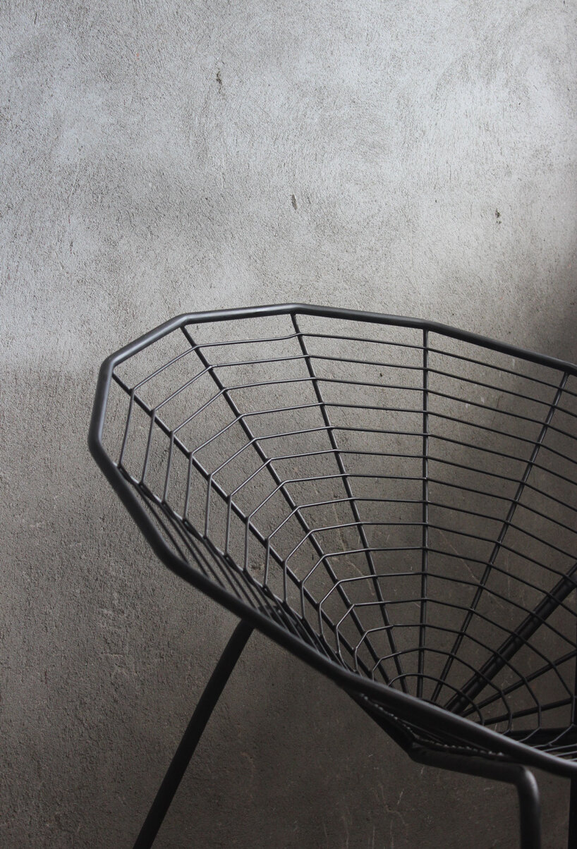this minimal black iron chair is inspired by spiders