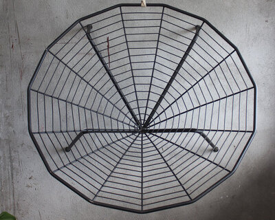 this minimal black iron chair is inspired by spiders