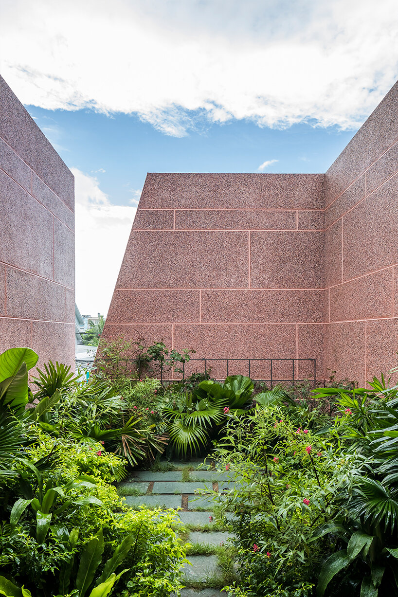 large circular roof opening punctures 23o5 studio's pink house in vietnam