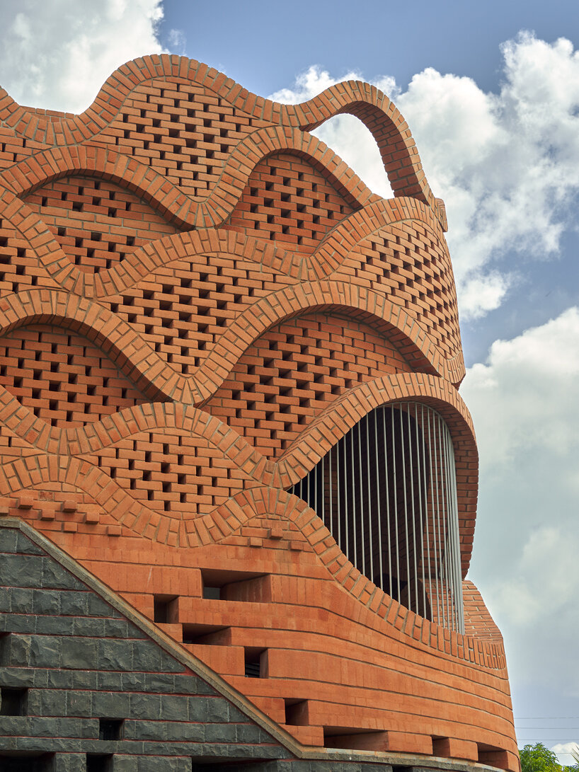 curved red bricks crown a family home in india designed by PMA madhushala