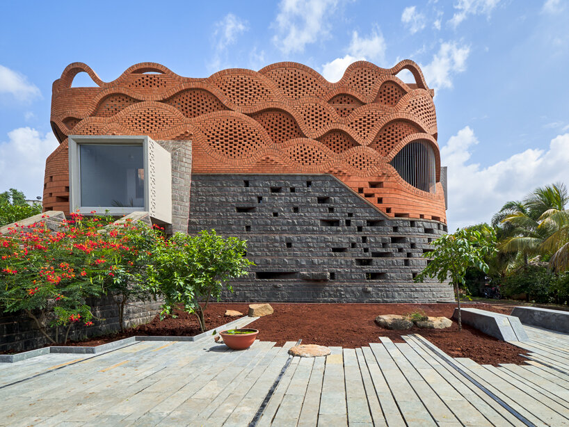 curved red bricks crown a family home in india designed by PMA madhushala