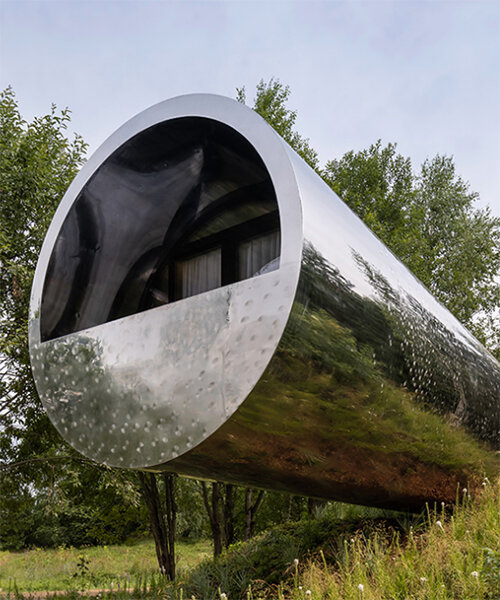 russian quintessential: suspended pipe-like house reflects the surrounding landscape