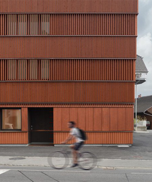 rusty red wooden guesthouse by ludescher + lutz revitalizes rhine valley town in germany