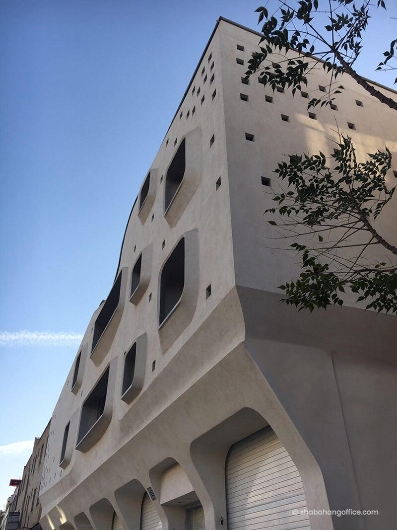 curved angles, extruded windows and square dots characterize futuristic building in iran