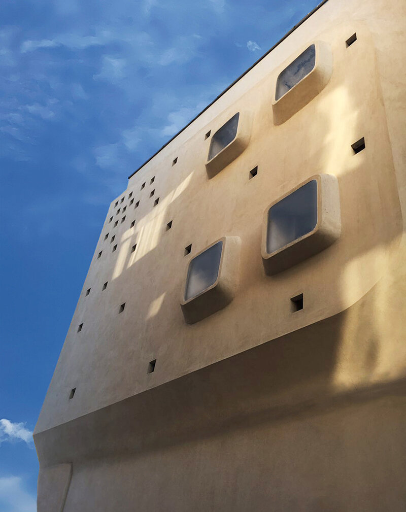 curved angles, extruded windows and square dots characterize futuristic building in iran