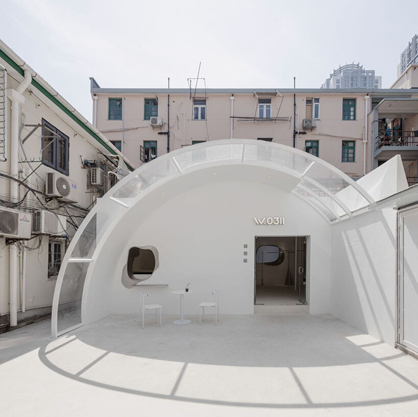 curvilinear display + minimal forms decorate this all-white clothing store in shanghai
