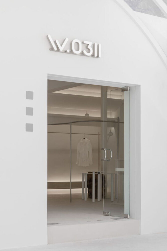 curvilinear display + minimal forms decorate this all-white clothing ...