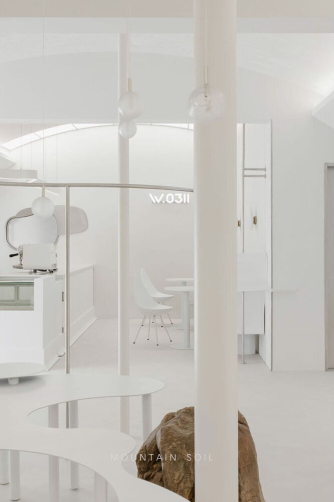 curvilinear display + minimal forms decorate this all-white clothing store in shanghai