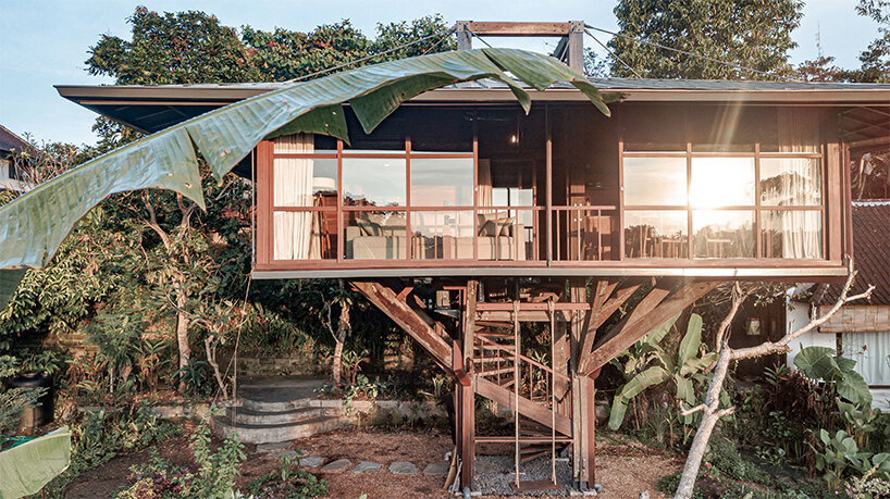 stilt studios' wooden treehouse C hovers above blooming garden in bali