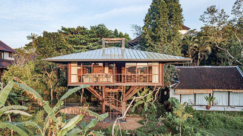 stilt studios' wooden treehouse C hovers above blooming garden in bali