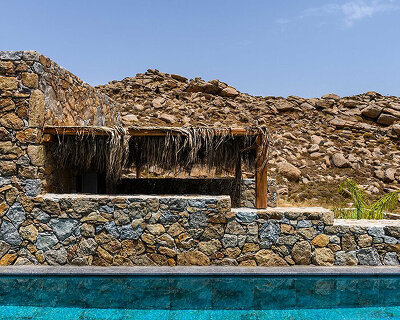 stone wellness resort for athlete rehabilitation is integrated into mykonian hillside, greece