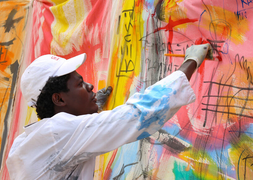 the slum studio is turning clothing waste into hand-painted apparel designboom