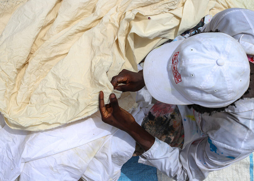 the slum studio is turning clothing waste into hand-painted apparel designboom