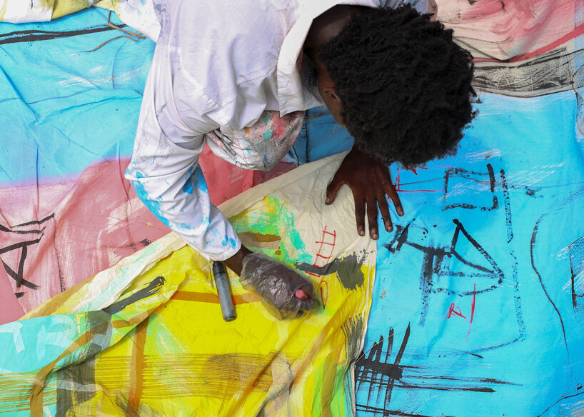 the slum studio is turning clothing waste into hand-painted apparel designboom