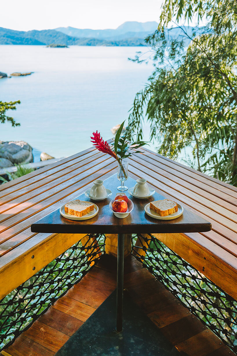 triangular 'casa proa' treehouse floats among coastal brazilian canopy