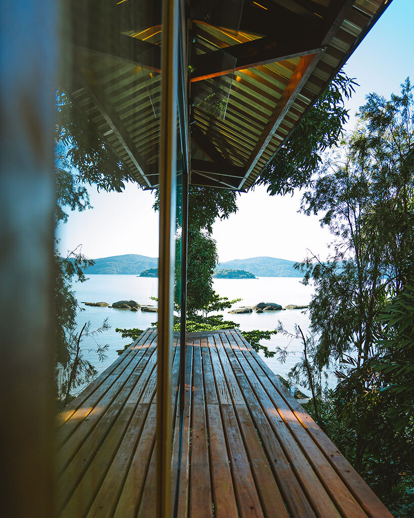 triangular 'casa proa' treehouse floats among coastal brazilian canopy