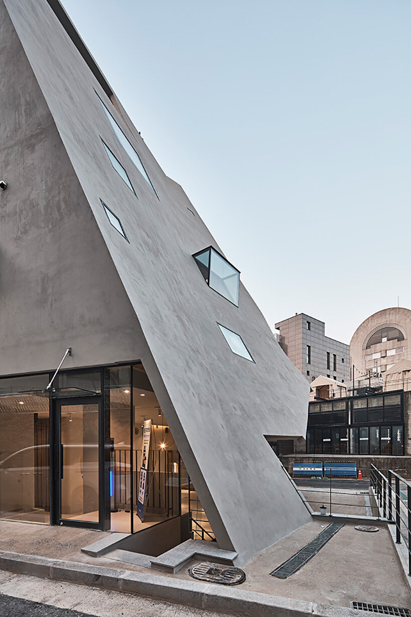 concrete pyramidoid spa by chiasmus stands out in the dense urban fabric of seoul
