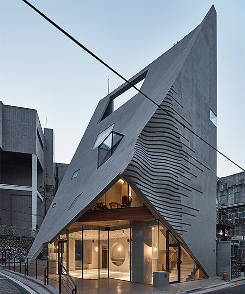 concrete pyramidoid spa with diverse cutouts stands out in the dense urban fabric of seoul