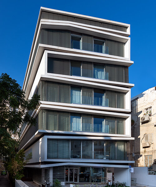ink hotel emerges as a pile of stacked books in the heart of tel aviv, israel