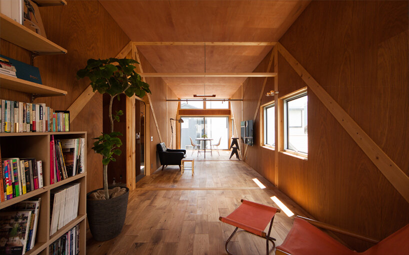 midorichio house in japan emerges from wooden skeleton forming a piloti