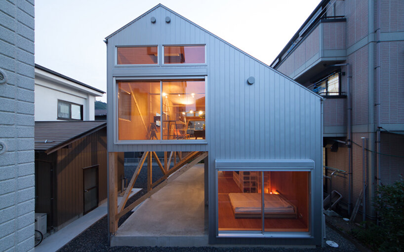 midorichio house in japan emerges from wooden skeleton forming a piloti