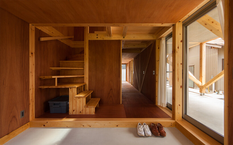 midorichio house in japan emerges from wooden skeleton forming a piloti