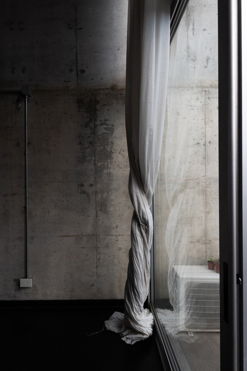 three vertical houses compose concrete 'triptico' building in córdoba, argentina