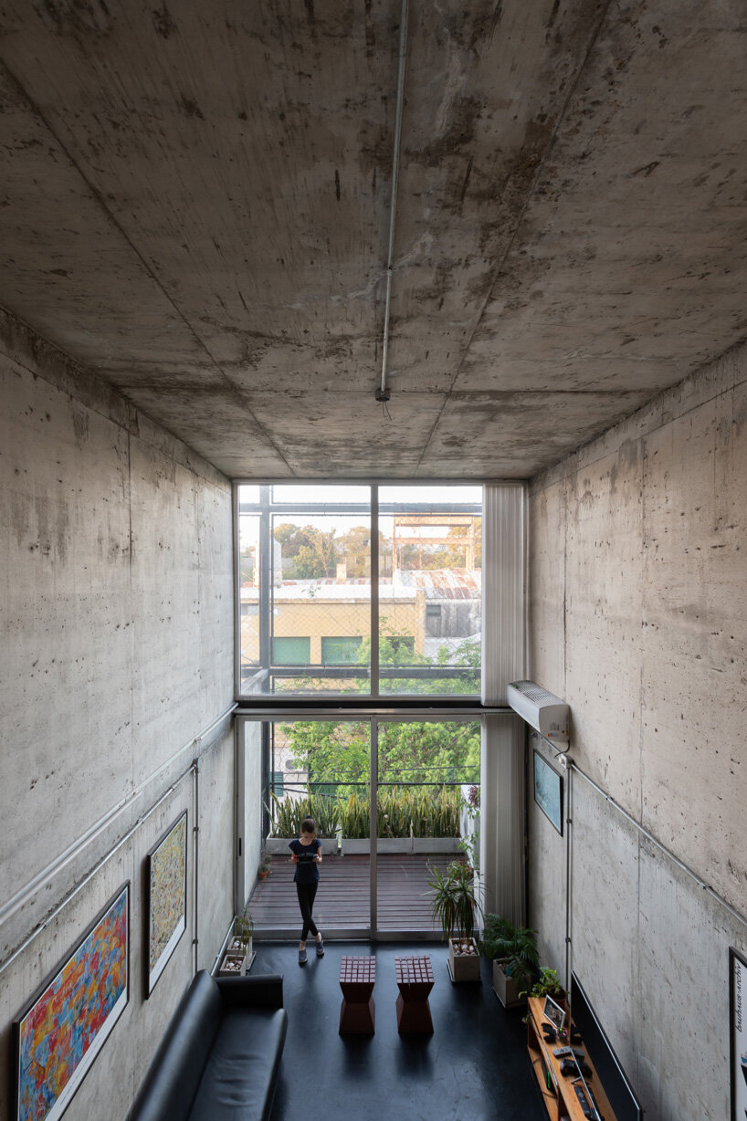 three vertical houses compose concrete 'triptico' building in córdoba, argentina