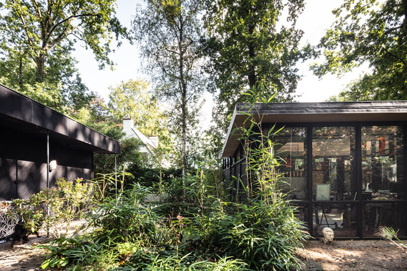 artist's prefab studio nestles in the leafy backyard of a 60s pavilion in belgium