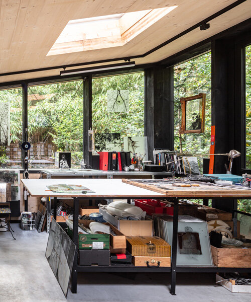 prefabricated artist studio nestles within the verdant backyard of a 60s bungalow in belgium