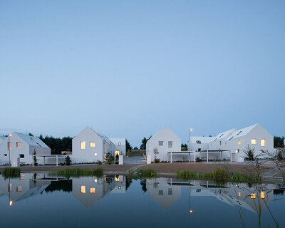 monom architects builds village-like housing complex in the czech republic